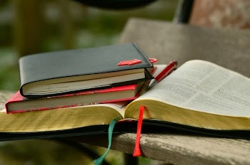 Black Hardbound Book on the Top of the Book