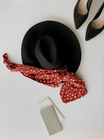 Black Hat Beside Pair of Black Pointed-toe Pumps