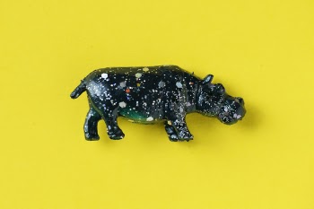 Black Hippo Figurine on Yellow Surface
