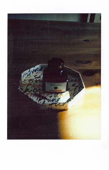 Black Ink Bottle on Plate
