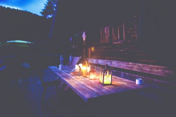 Black Lantern on Brown Wooden Table Under Blue Sky