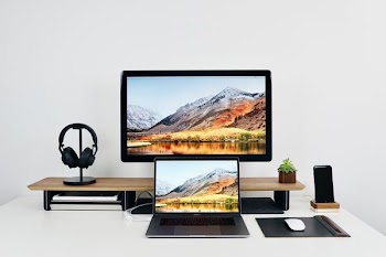 black laptop behind flat screen TV