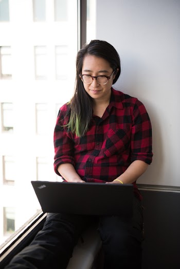 Black Laptop Computer on Woman's Lap