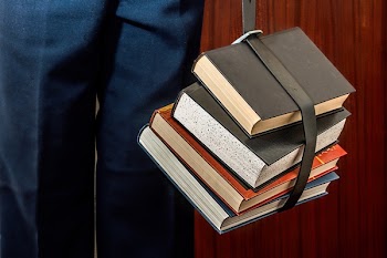 Black Leather Book Strapped Around Four Books