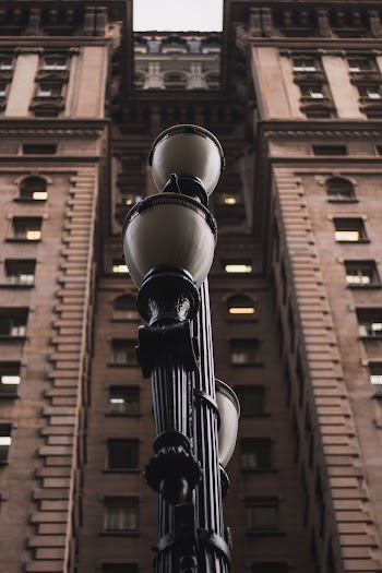 Black Light Post in Front of Brown Building