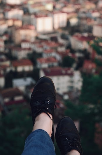 Black Low-top Shoes on a Person's feet