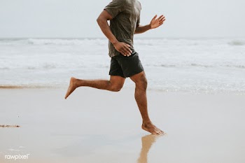 Black man running on the beach