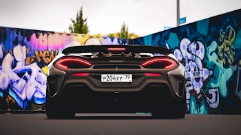 Black Mclaren Vehicle Near Wall