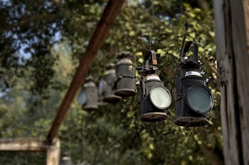 Black Metal Lanterns Hanged in Brown Wooden Frame
