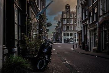 Black Motor Scooter Parked Near Building