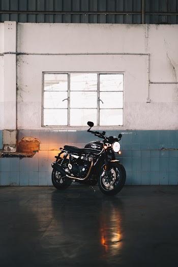 Black Motorcycle Near White And Blue Wall