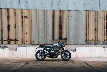 Black Motorcycle Parked Outside A Building