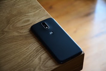 Black Motorola Smartphone on Top of Brown Wooden Table