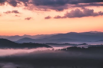 black mountain covered with fogs