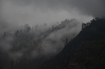 black mountain surrounded by fog