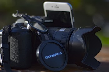 Black Olympus Dslr Camera Beside Silver Iphone 6