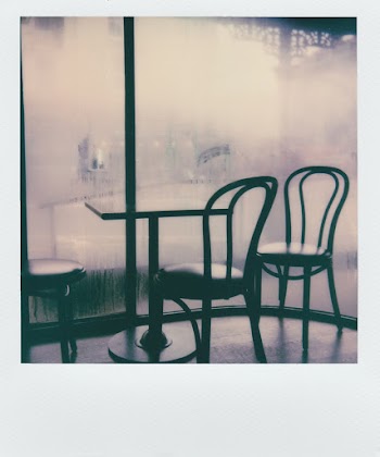 Black Padded Chairs Near Table Beside Glass Wall