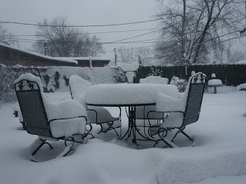 Black Patio Table and Chairs Covered of Snow
