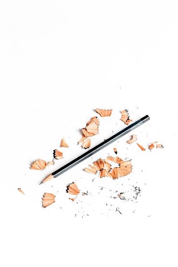 black pencil surrounded by pencil husk