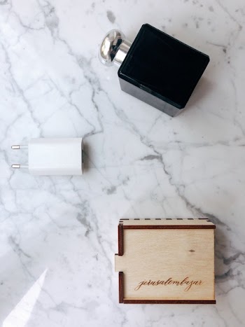 Black Perfume Bottle Beside Adapter