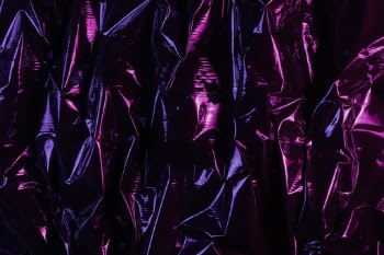 Black plastic foil lit with two improvised color gel lamps.