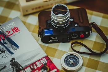 black point-and-shoot camera near compass