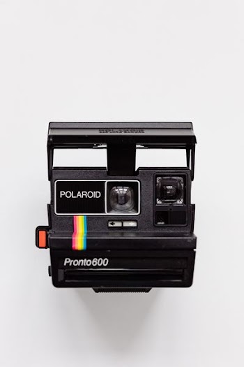 black Polaroid camera with white background