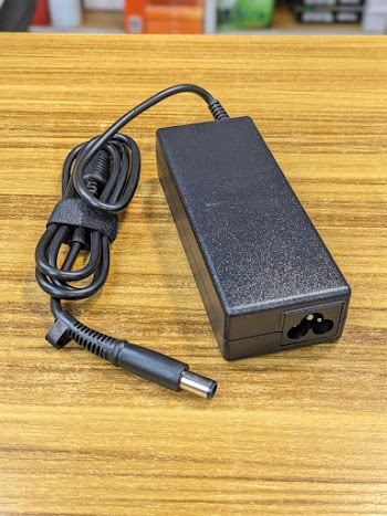 Black Power Adapter on Wooden Table