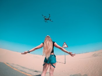 Black Quadcopter Over Woman Wearing Black Shirt 