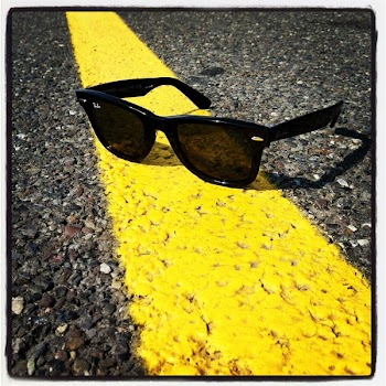 Black Ray-ban Wayfarer Sunglasses over Yellow Line on Street