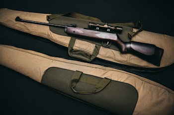 Black Rifle With Scope and Brown Gig Bag