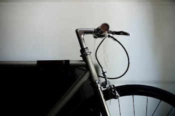black road bicycle beside wall