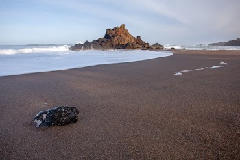 Black Rock on Sandy Beach