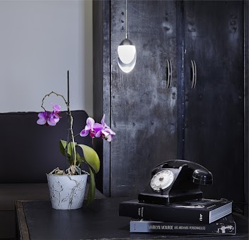 Black Rotary Telephone on Black Book Cover