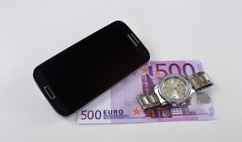Black Samsung Galaxy Smartphone Beside Silver-colored Watch