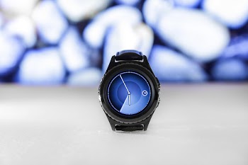 Black Samsung Gear Displaying 05:55 on White Surface