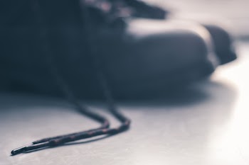 Black Shoelace Placed on Gray Floor