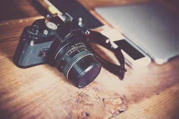 Black Slr Camera on Wooden Surface