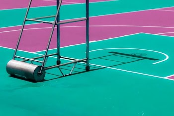 black steel basketball hoop stand on concrete surface
