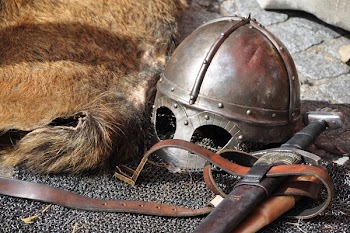Black Steel Helmet Near Black and Gray Handle Sword