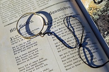Black String on Top of an Open Book during Daytime