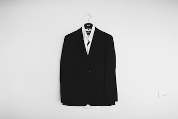 black suit jacket hanged on wall