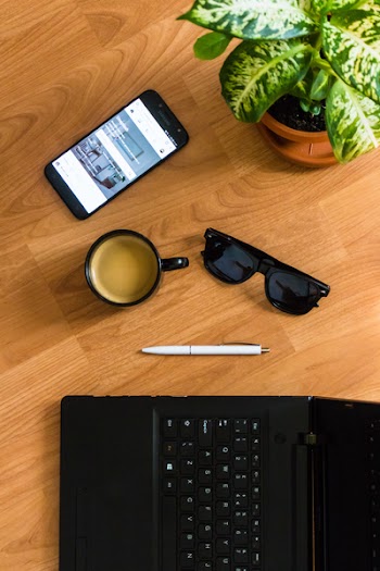 Black Sunglasses on Brown Wooden Surface