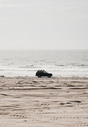 black SUV parked near seashore