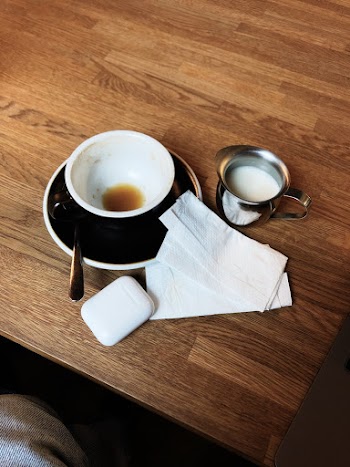 Black Teacup and Saucer on Table