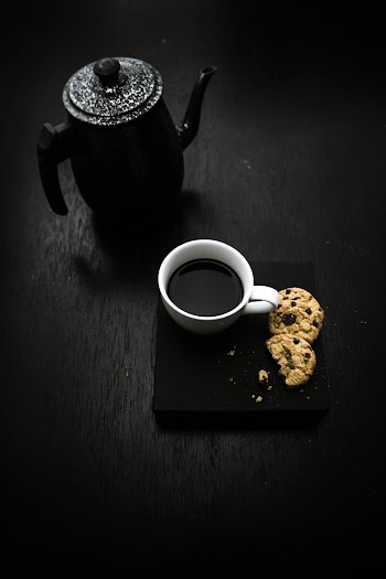 Black Teapot Beside Teacup