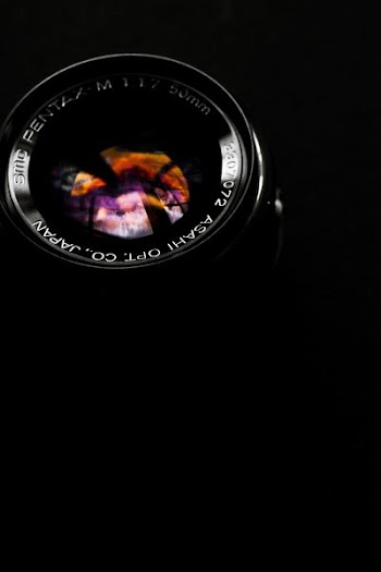 black telephoto lens on black surface