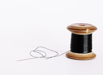 Black Thread On A Wooden Spool