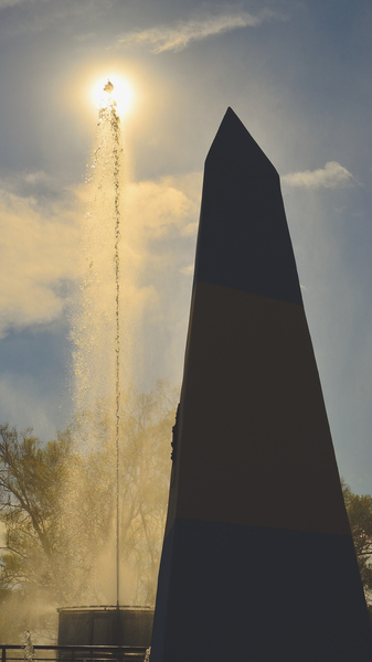 Black Tower Near Fountain Under Blue Sky and White Clouds