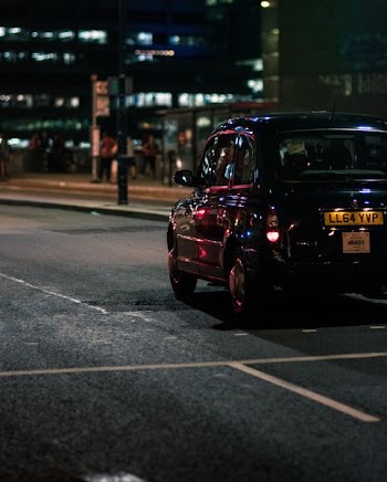 black vehicle on gray concrete road during nighttime